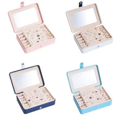 Four open jewelry boxes in pink, white, blue, and beige with jewelry inside on a white background.
