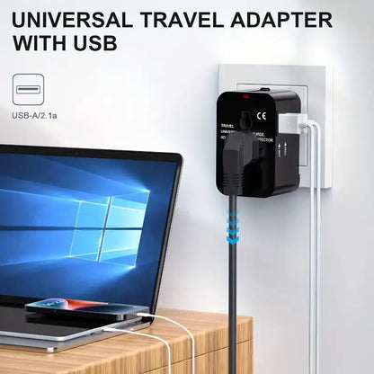Universal travel adapter with USB plugged into a laptop on a wooden surface.