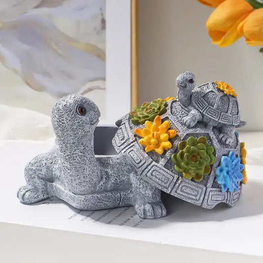 Decorative turtle figurine with floral decorations on a light background