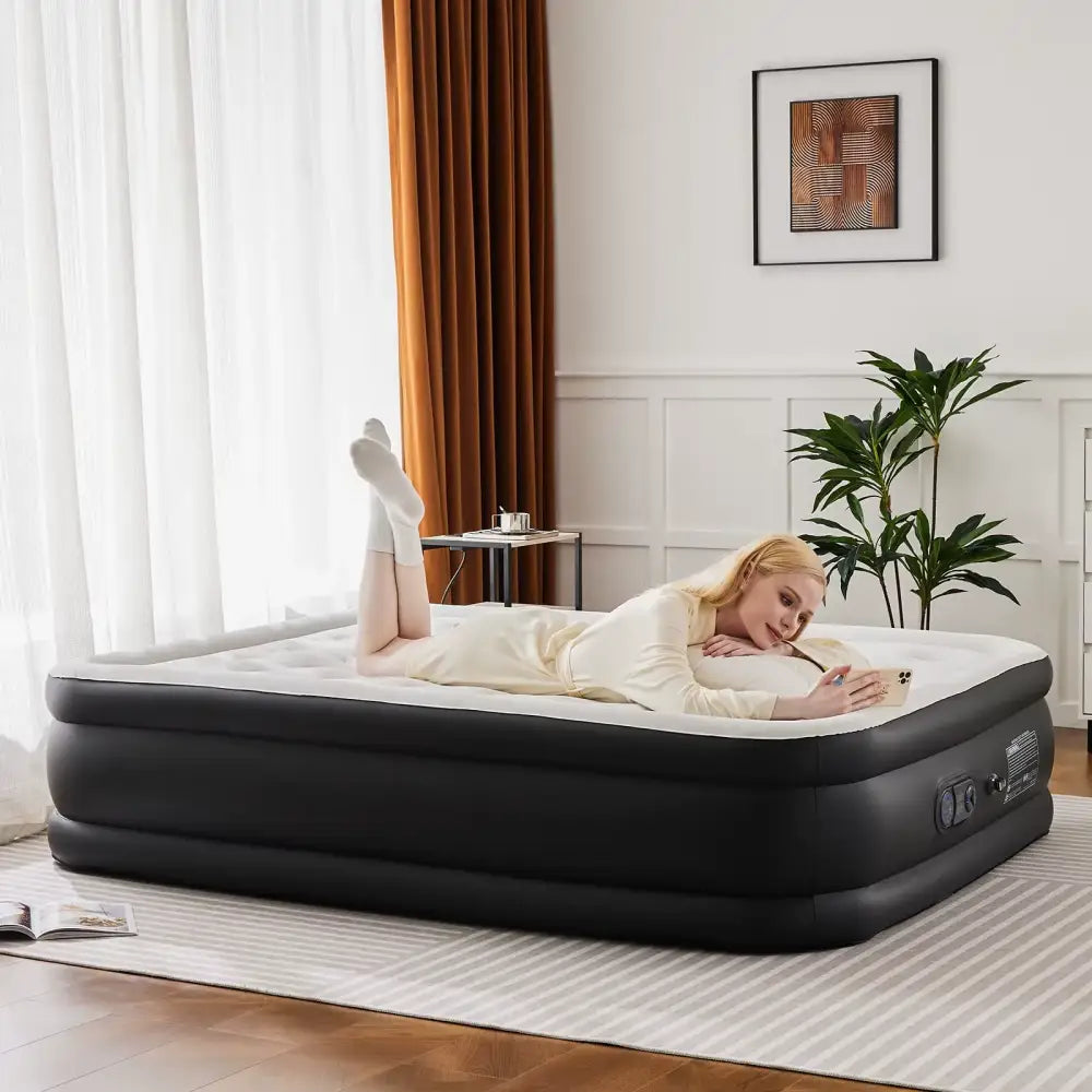 Woman lying on an inflatable mattress in a room with curtains and a plant.