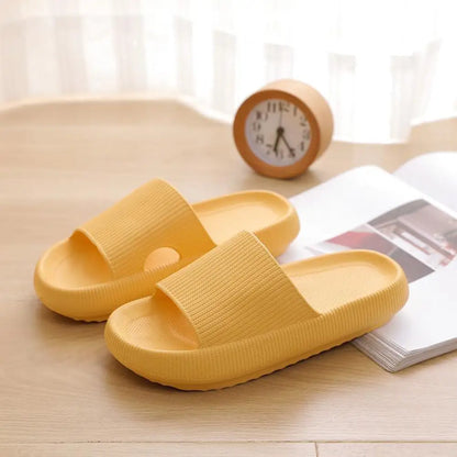 Yellow slippers on a wooden surface with a clock and magazine in the background