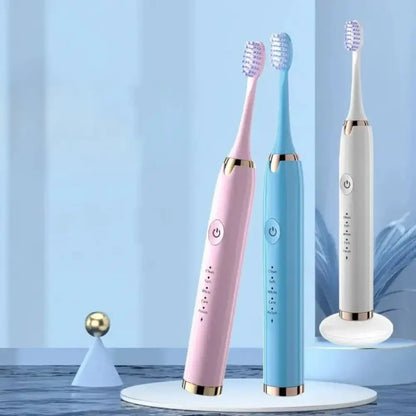 Three colorful electric toothbrushes on a stand with a light blue background