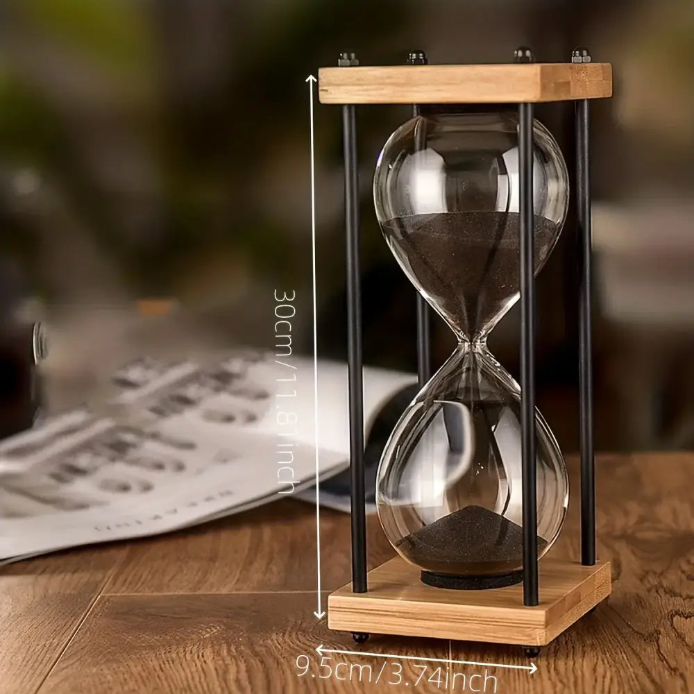 Black sand hourglass showing stark contrast between dark sand and vintage wooden frame