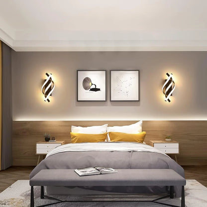Modern bedroom with a bed, nightstands, and wall lights.