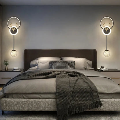 Modern bedroom with a bed, wall lights, and decor.
