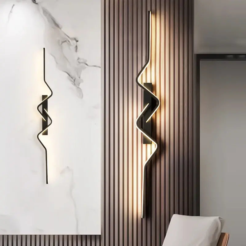 Modern wall lights with abstract design on a marble and striped wall.