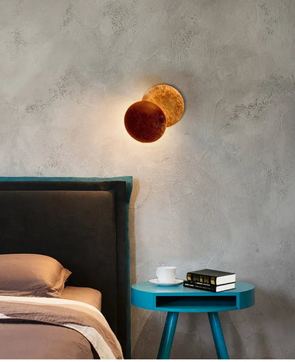 Modern bedroom with a bed, nightstand, and wall sconces.