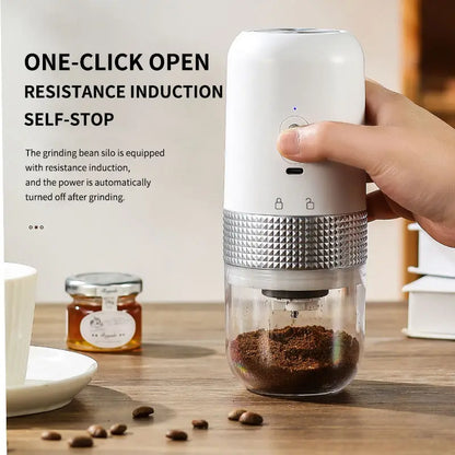 Hand holding a white coffee grinder with text on resistance induction and self-stop feature, placed on a wooden surface with coffee beans and a jar.